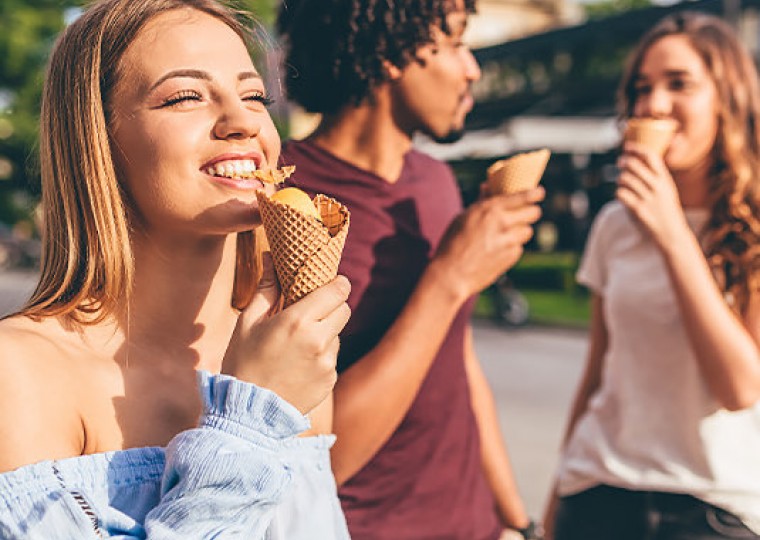 three friends eating ice cream cones