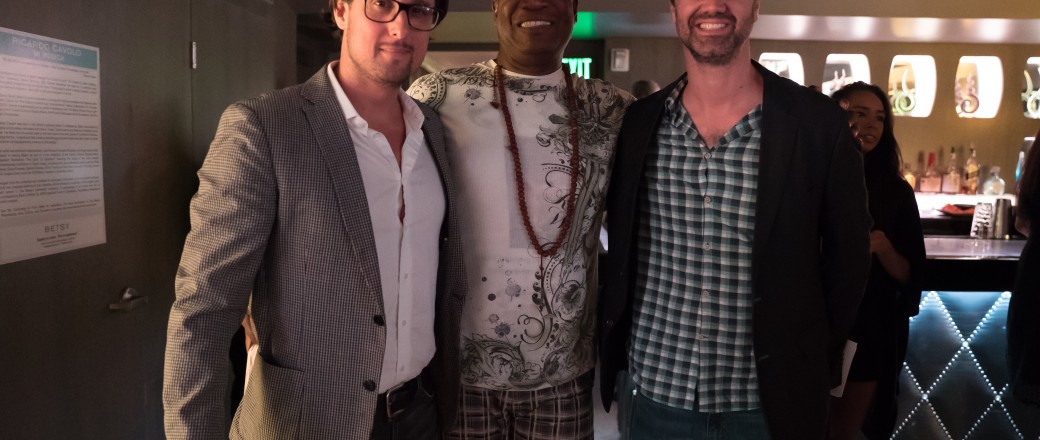 Three men posing for photo