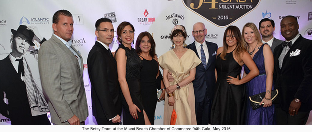 Group of people posing for photo at gala