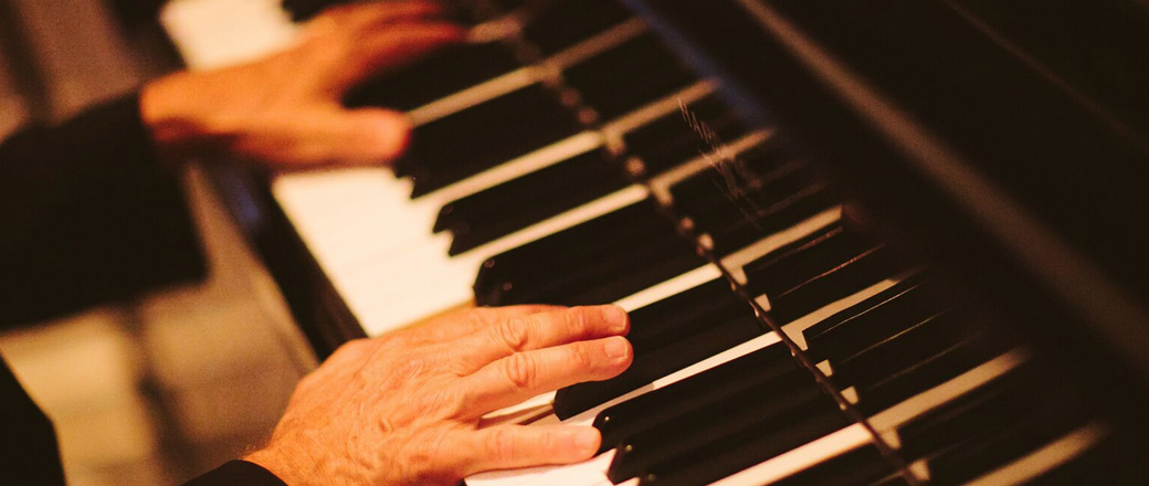 Close up of hands playing piano