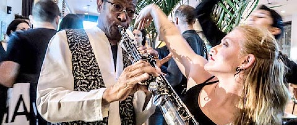 Woman dancing next to man playing clarinet