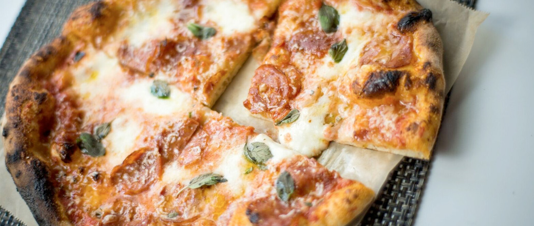 Personal pizza with pepperoni, basil & cheese