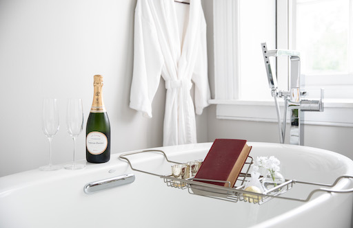bath tube with champagne and book