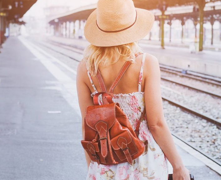 Back view of a woman with a cute hat and a flowered dress