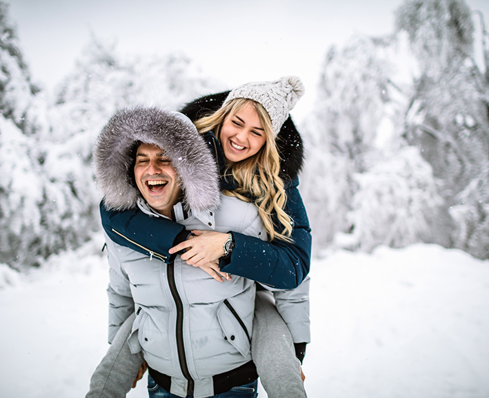 View of a happy couple playing in the snow