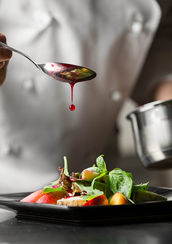 Closeup view of a chef serving a gourmet dish