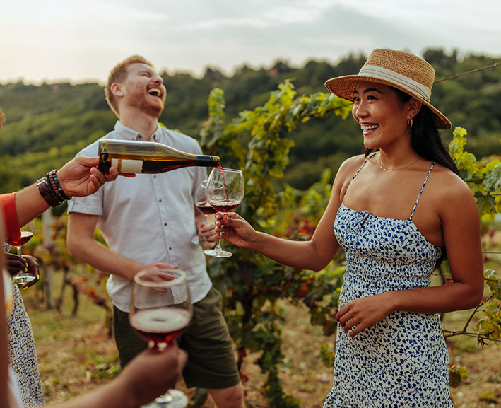 A group of friends drinking wine at a winery