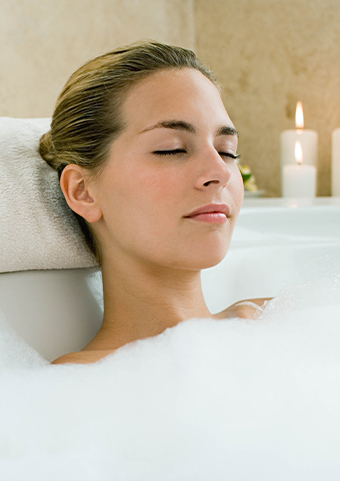 Closeup of a relaxed woman at a fancy bathtub