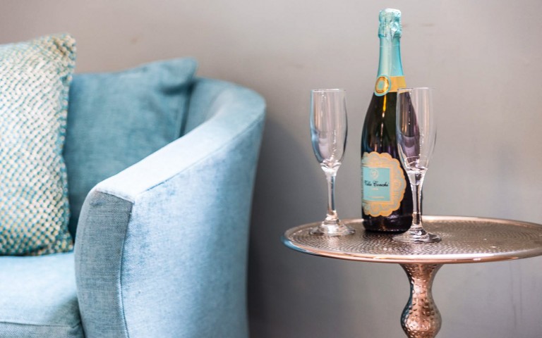 Closeup of a table with a bottle of champaign and two glasses 