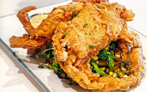 fried seafood on top of greens