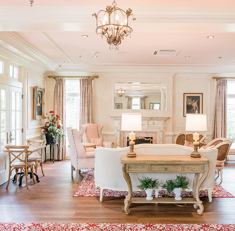 Pinky and spacious living room with features as lamps and comfy couch and chairs