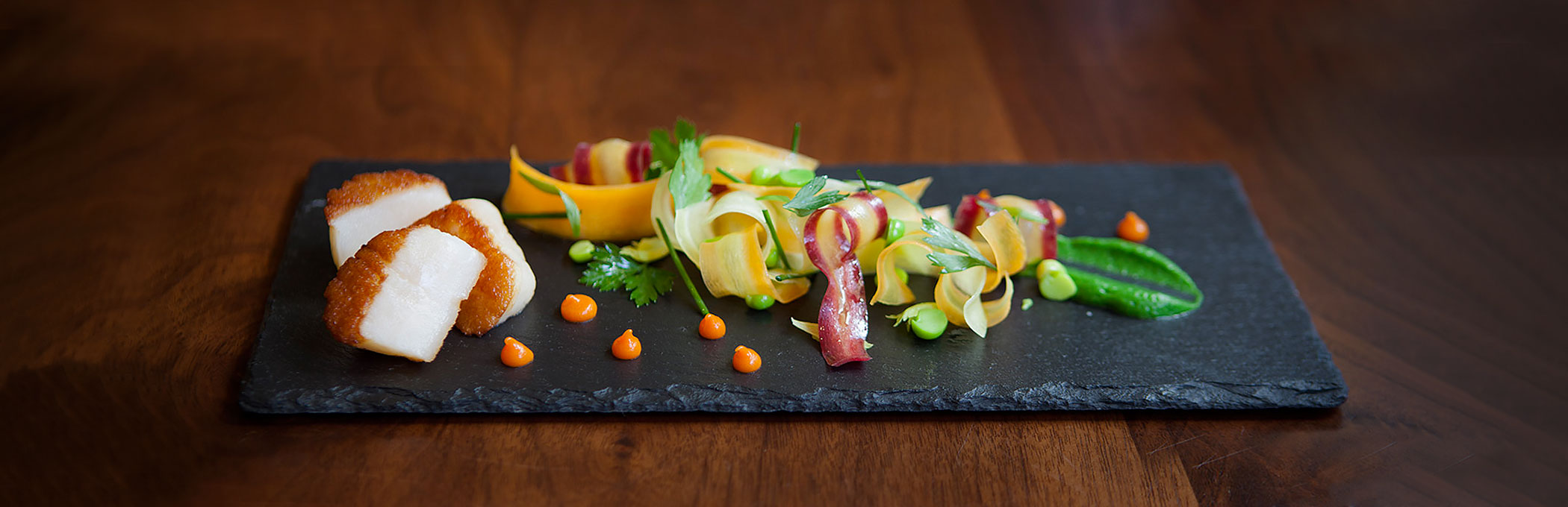 Salad with tender meat on black rock slab