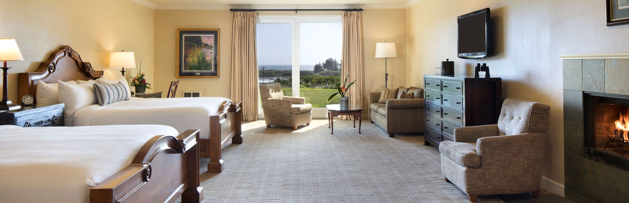 Room with two double beds, dresser, TV, Seating area & porch