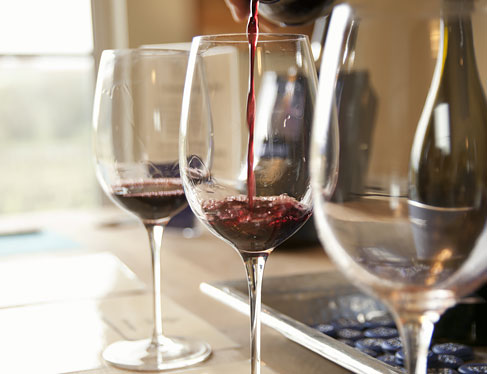 Red wine being poured into glasses