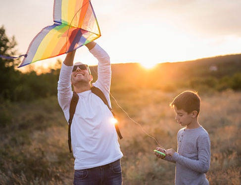 Dad and son prepping kite for flight