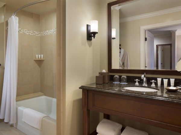 Full bathroom with shower, wooden vanity & sink