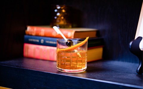 old fashioned on book shelf with books behind the glass