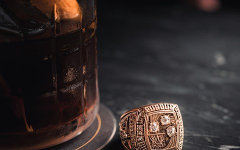 pursue class ring on table next to cocktail