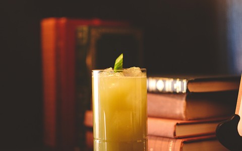 Yellow cocktail on bookshelf