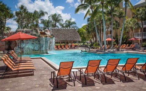 pool area with lounge chairs and umbrellas 