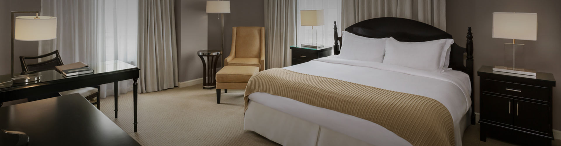 up close of bed and chair in a hotel room h