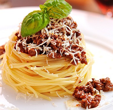 Spaghetti Bolognese garnished with fresh basil 