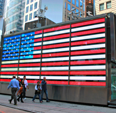 memorial day flag displayed electronically on side of metal building in Times Square