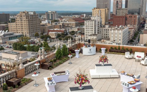 Exterior view of the Rooftop Lounge at our hotel in Louisville, KY. Rooftop is outfitted with furniture, flowers, & catering 