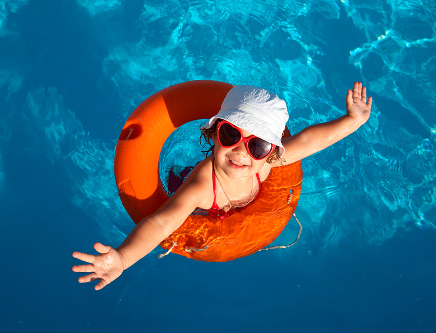 Little girl in an orange pool float