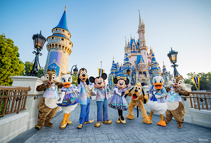 disney characters standing in front of the magic kingdom castle