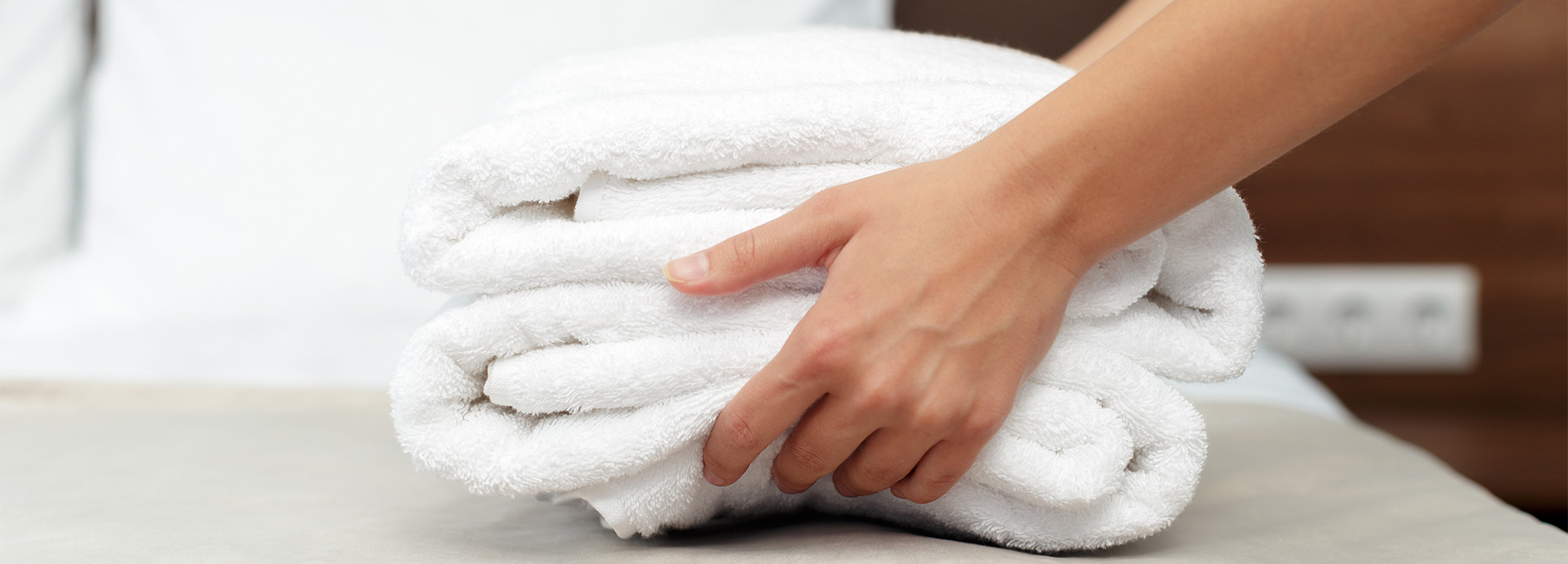 Person holding folded towels