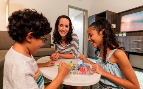 Mother plating board games with her children 