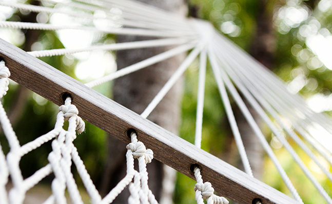 Close up of woven string & wood of hammock Image