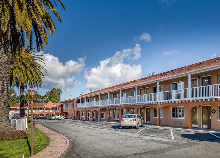 Street view of the two story hotel building where the doors to the rooms are located