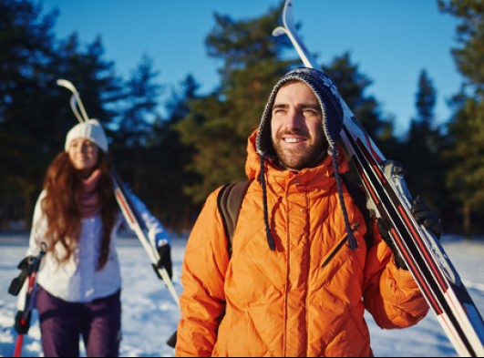 couple holding skis