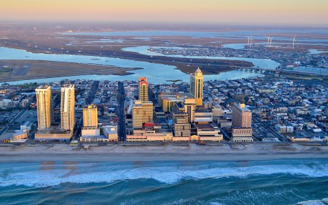 A drone shot of the beach and the buildings in Atlantic City.