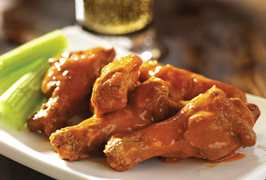 Chicken wings served with celery.