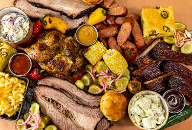 A platter with a variety of bbq foods.