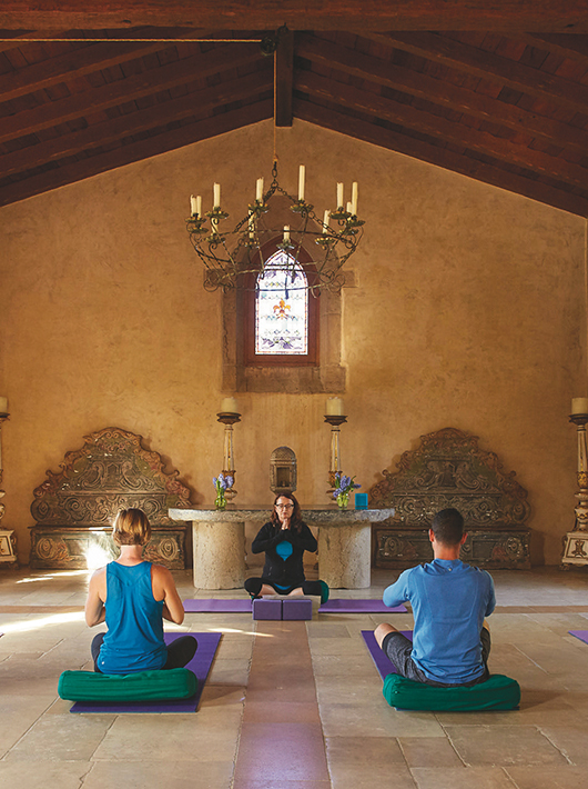 three people meditating in chapel