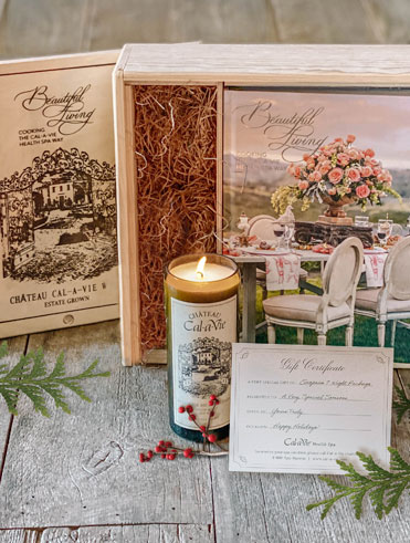 candle and cookbook in wood box on floor surroundled by leaves