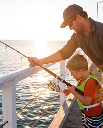View of a father teaching his son to fishing