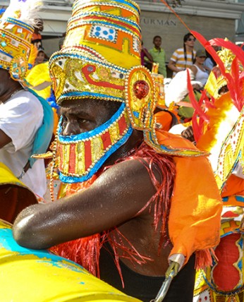 A bahamian man wearing a traditional colorful costume