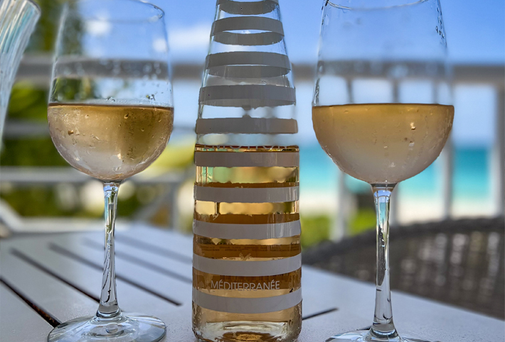 Close up of two glasses of wine with a bottle