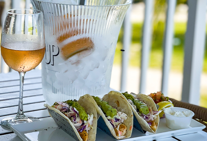 Front view of a taco dish and a champaign glass at the Harbour Pointe restaurant