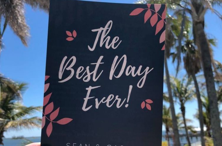 wedding invitation hold over beach background