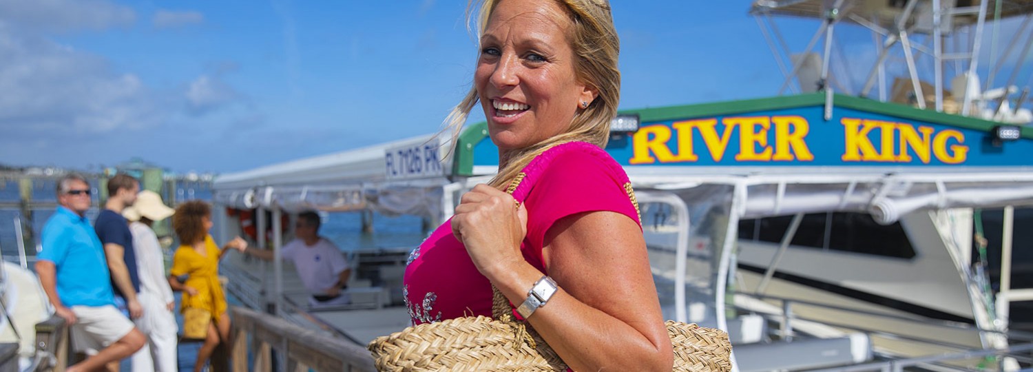 woman with hand bag getting on boat