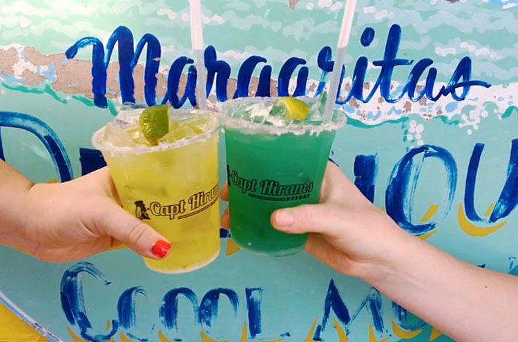 two hands cheering coctails