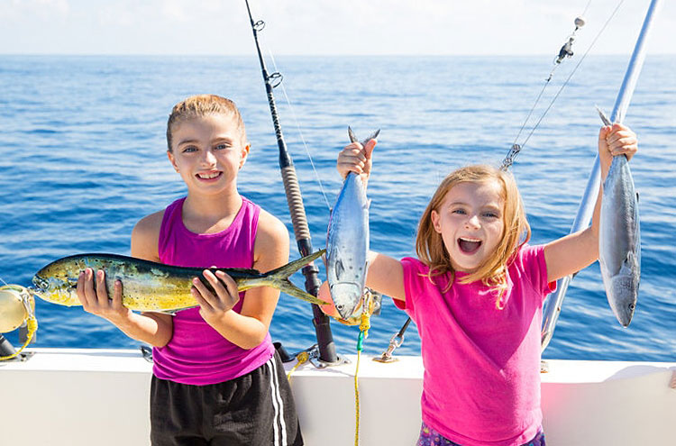 young girls holding fish
