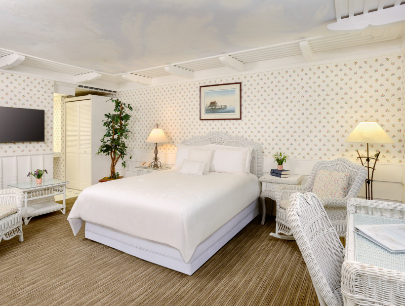 guest room with white furniture and white bed sheets