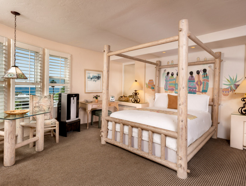 guest room with a white wooden bed frame, table, and nightstand, 